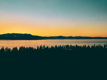 Scenic view of lake against sky during sunset