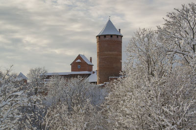 Old castle in winter under cloudy sky