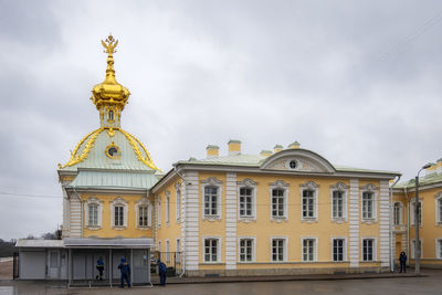 Low angle view of building against cloudy sky