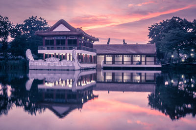 Reflection of building in lake at sunset