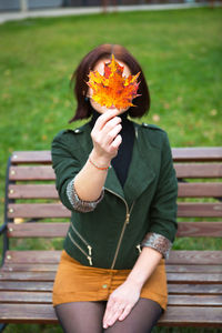 Woman sitting on bench in park