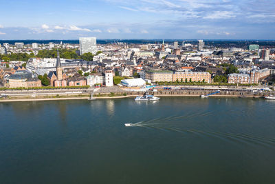 High angle view of townscape by sea against sky