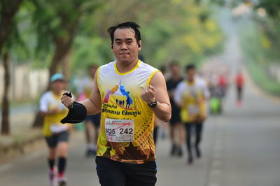 Portrait of man running in city