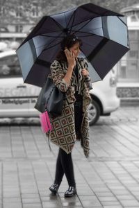 Full length of woman standing by railing