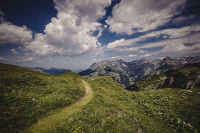 Scenic view of mountains against cloudy sky