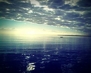 View of calm sea against cloudy sky