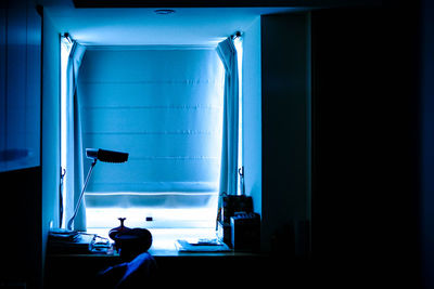 View of illuminated desk in darkroom