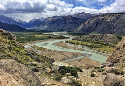 Scenic view of valley and mountains against sky