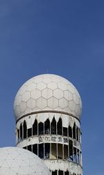 Low angle view of tower against blue sky