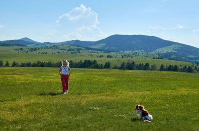 Woman and dog in a wonderful mountain landscape in spring