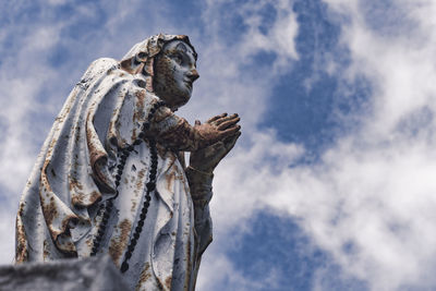 Low angle view of statue against sky