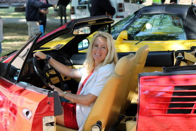 Portrait of woman sitting in modern car