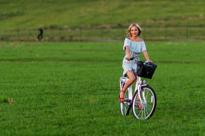 Man riding bicycle on field