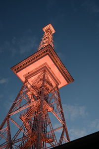 Low angle view of communications tower against sky