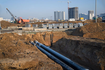 Construction site in city against sky