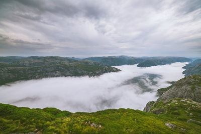 Scenic view of clouds amidst mountains against sky