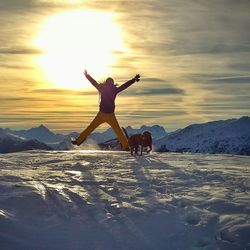 Woman jumping in sky at sunset