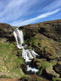 Scenic view of waterfall against sky