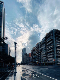 City street and buildings against sky