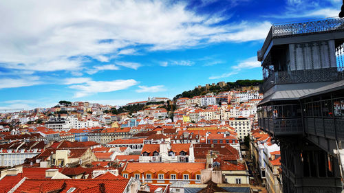 High angle view of houses in town against sky