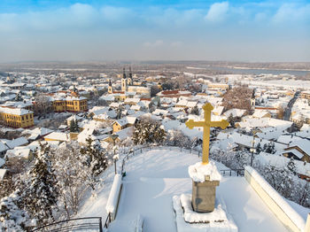 High angle view of snow covered cityscape against sky