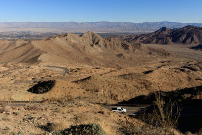 Scenic view of land and mountains against sky