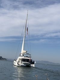Sailboat sailing on sea against sky