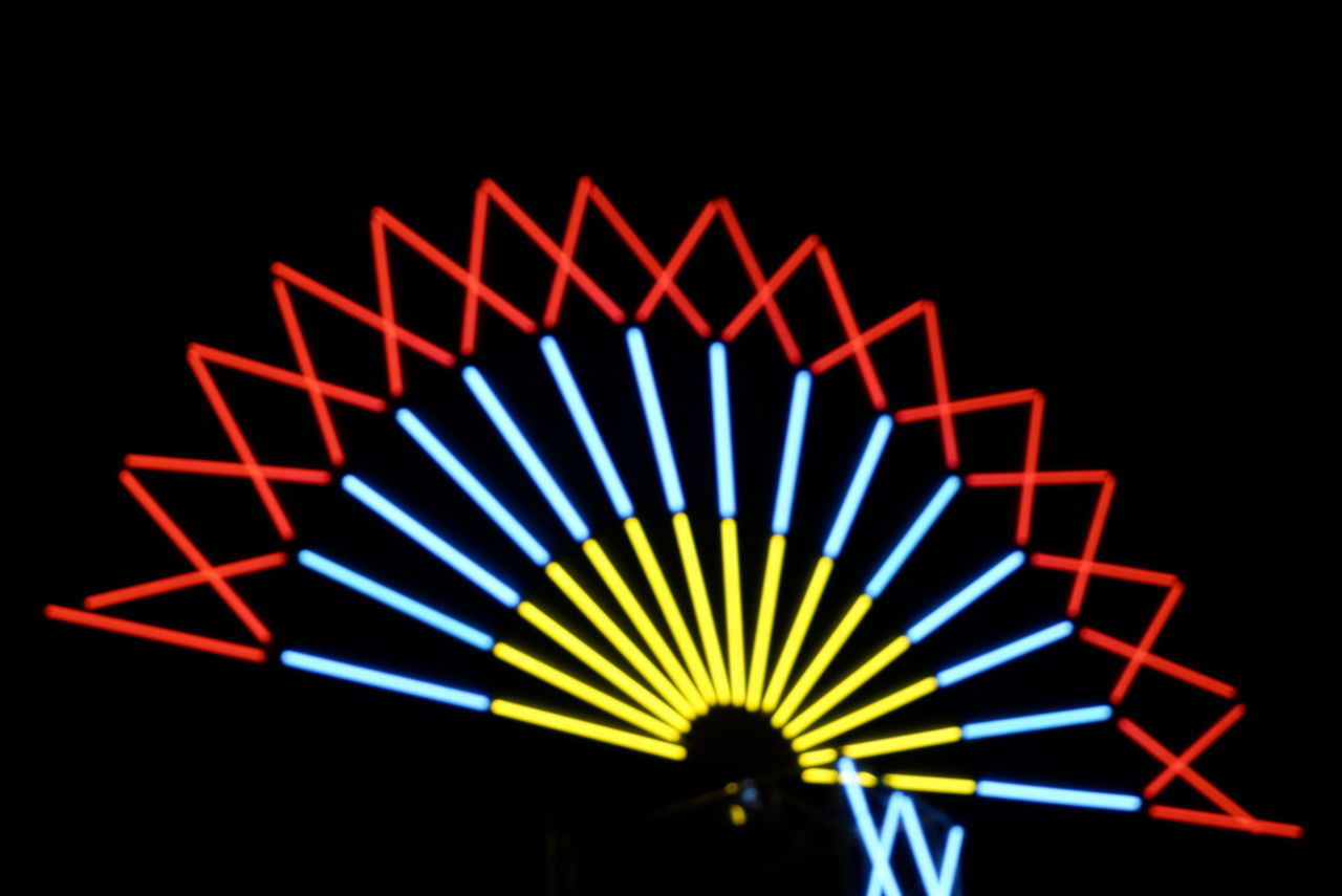 LOW ANGLE VIEW OF ILLUMINATED LIGHTS AT NIGHT