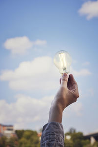 Hand holding lightbulb