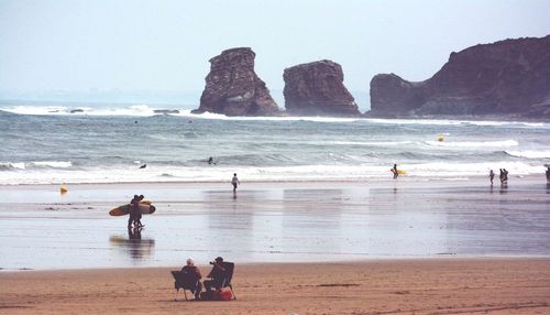 Surfers walking on the beach