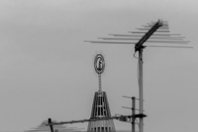 Low angle view of communications tower against sky