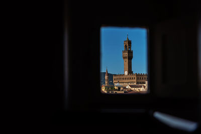 Clock tower against building in city