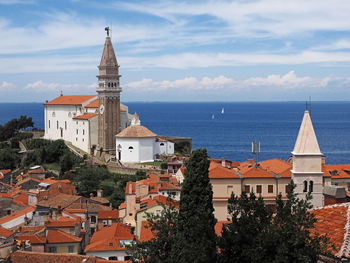 Traditional church by sea against sky