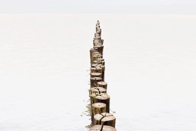 High angle view of wooden posts at beach
