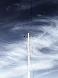 Low angle view of communications tower against sky