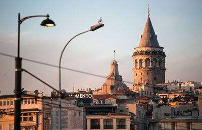 Buildings against sky at sunset