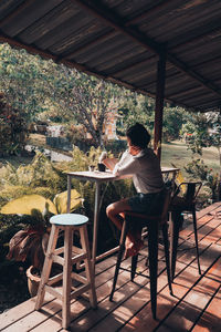 Woman sitting on chair at table