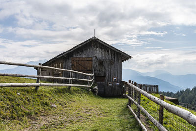 Built structure on field against sky