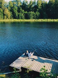 High angle view of people relaxing by lake