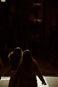 Rear view of woman walking on street