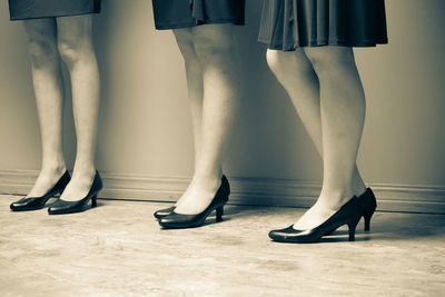 Low section of woman standing on tiled floor