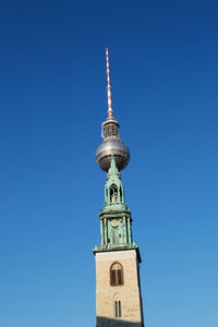 Low angle view of st marys church and fernsehturm against clear sky