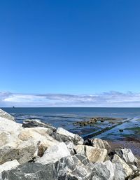 Scenic view of sea against blue sky