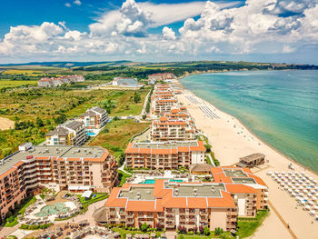 High angle view of buildings and sea against sky