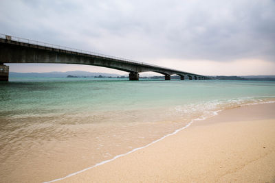 Bridge over sea against sky