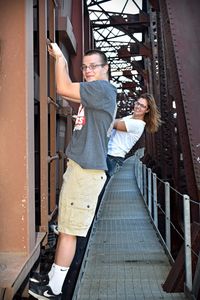 Young couple standing on the wall