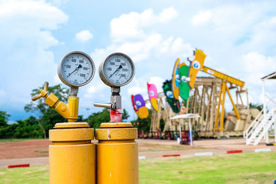 Close-up of yellow bottles against sky