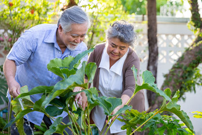 Two women sitting on plants