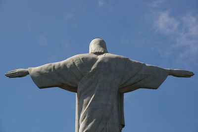 Low angle view of statue against blue sky