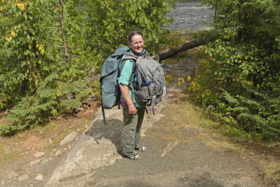 Man walking on footpath in forest